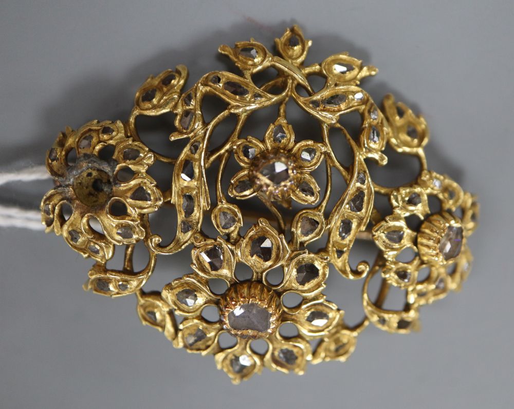 A continental yellow metal and rose cut diamond set foliate pendant brooch,(lead solder repair verso), 44mm, gross 14.3 grams.